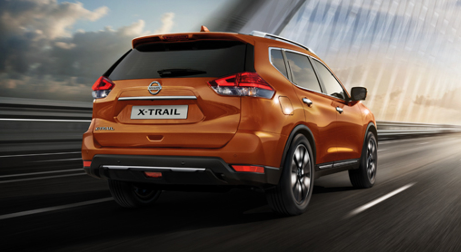 Orange Nissan X-Trail driving  away on bridge