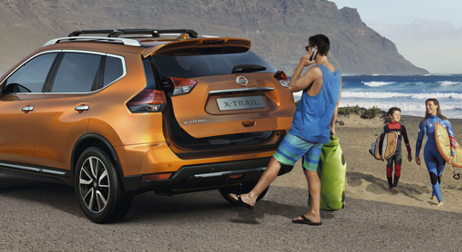 Man demonstrating open sensor on orange Nissan X-Trail